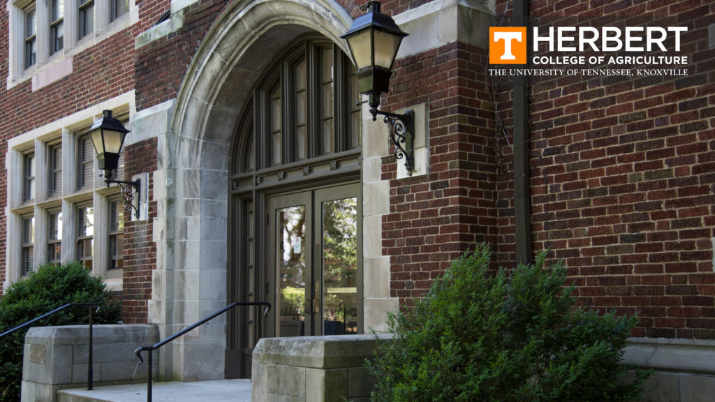 A close-up of the front entrance of Morgan Hall with the Herbert College of Agriculture logo in the upper right corner